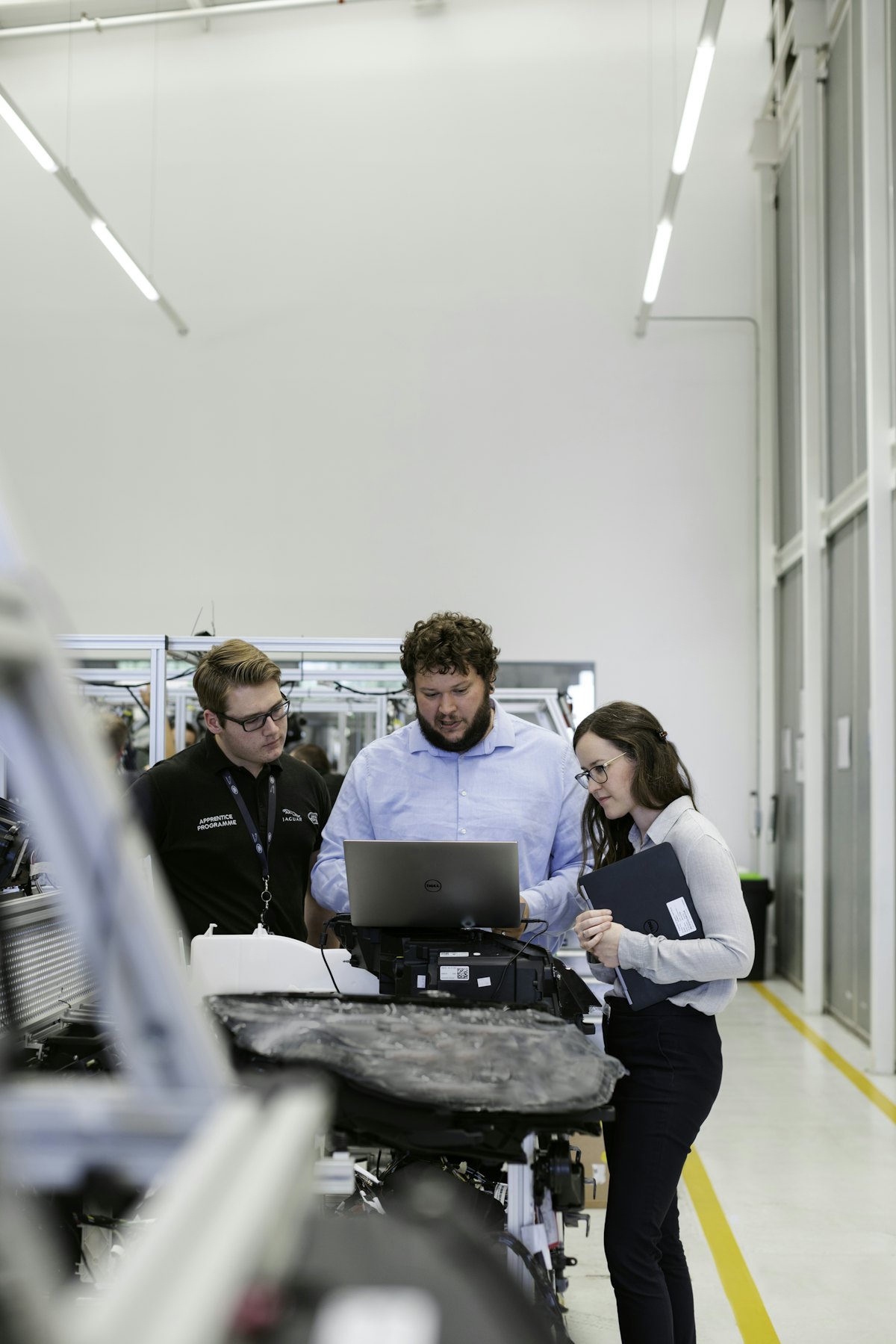 Engineering team working around a laptop